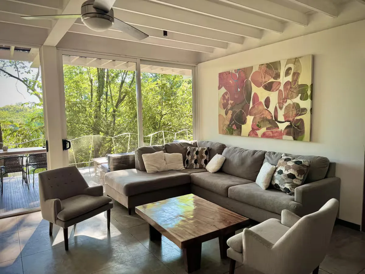 Living room with sectional sofa, opening to the deck